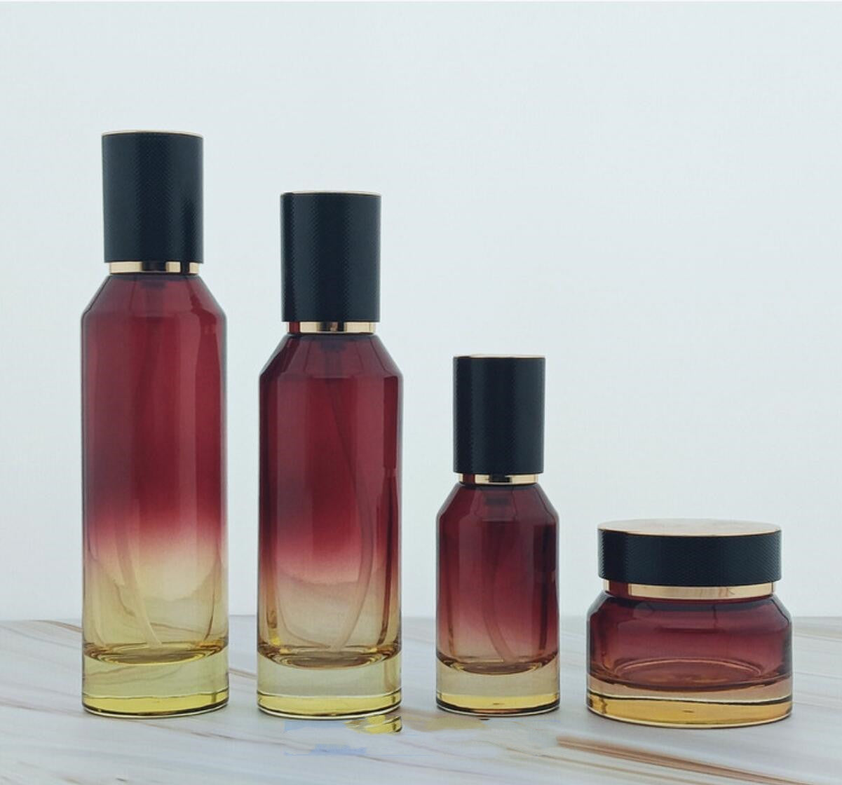 high quality luxury red colour cosmetic glass bottles slant cosmetic glass package with lid wholesale